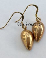 Small gold teardrop earrings.