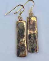 Gold rectangular drop earrings.