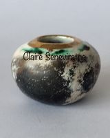 Small smoked fired vessel with gold.