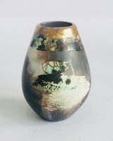Small upright smoke-fired ceramic pot.