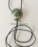 Round raku pendant with greens,greys and white.