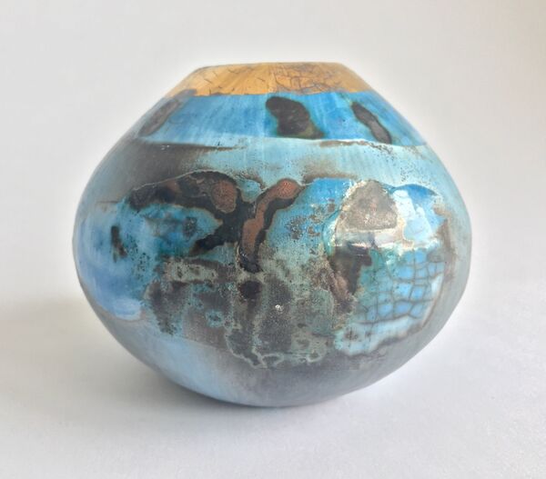 Small blue smoke-fired pot with gold lustre.