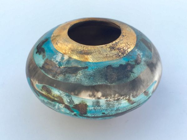 Blue and gold pit-fired vessel.