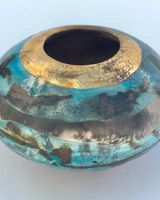 Blue and gold pit-fired vessel.