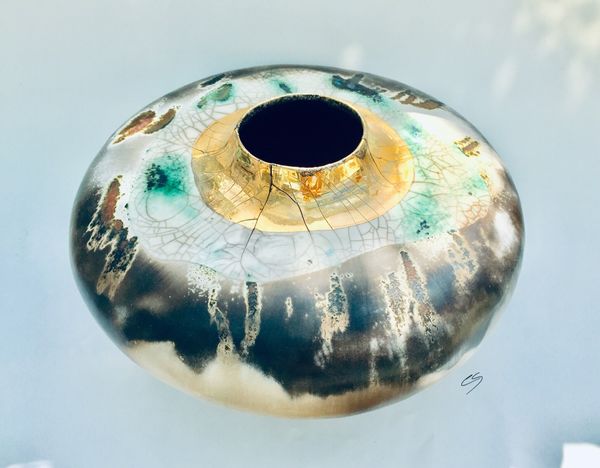 Large round smoke fired pot with gold lustre.