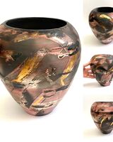 Red smoke-fired pot with gold lustre.