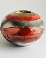 Red smoke-fired pot with gold lustre.