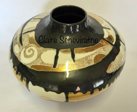 Ceramic pot with gold lustre.