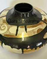Ceramic pot with gold lustre.