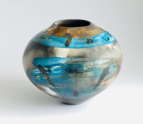 Blue burnished smoke-fired ceramic pot with gold lustre.