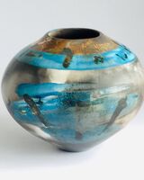 Blue burnished smoke-fired ceramic pot with gold lustre.