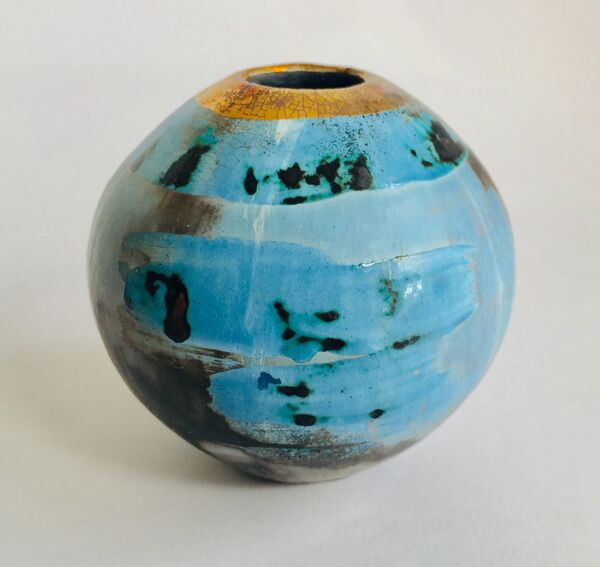 Small blue smoke-fired pot with gold lustre.