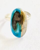 Blue porcelain ring on a sterling silver adjustable band.