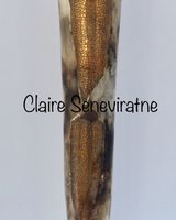 Tall smoke-fired pot with gold lustre.