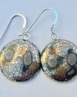 Silver round earrings with crackled glaze.