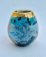 Small blue smoke-fired pot with gold lustre.