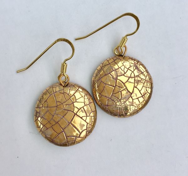 Round ceramic earrings with glaze and gold lustre.