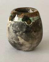 Tiny upright smoke fired pot.