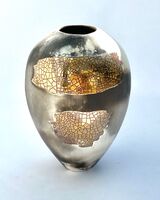 Small upright gold lustre smoke-fired porcelain pot.