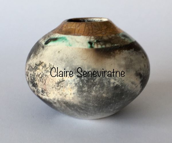 Round smoke fired pot with gold.