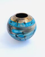 Blue smoke-fired ceramic pot with glaze and gold lustre.