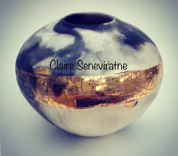 Small ceramic pot with gold lustre.