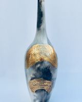 Smoke fired pot with long neck.