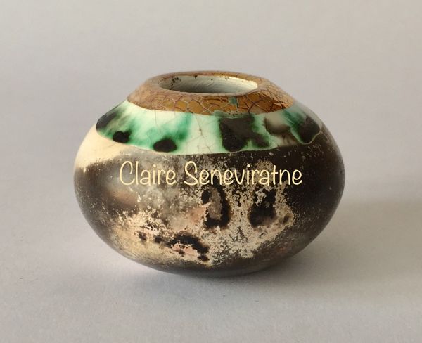 Small smoke fired pot with gold.