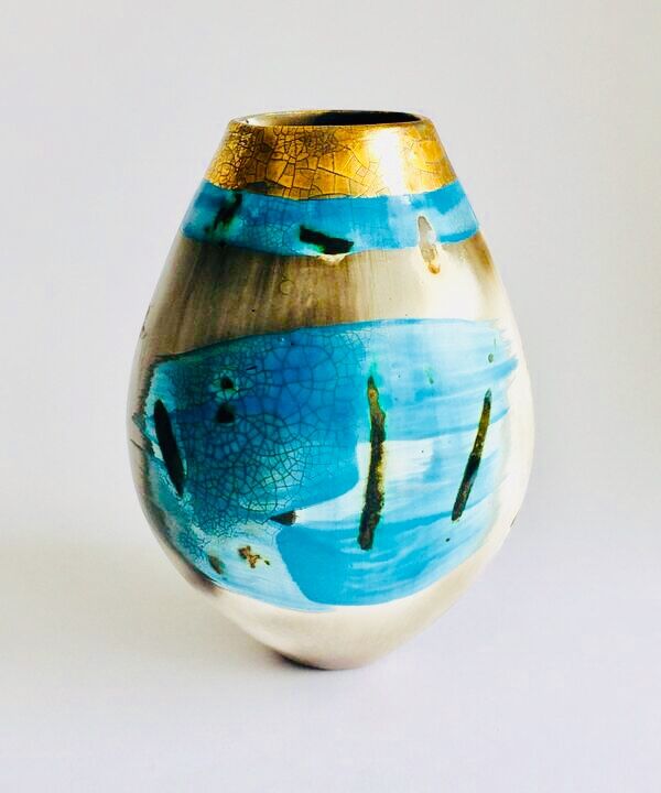 Blue smoke-fired ceramic pot with glaze and gold lustre.