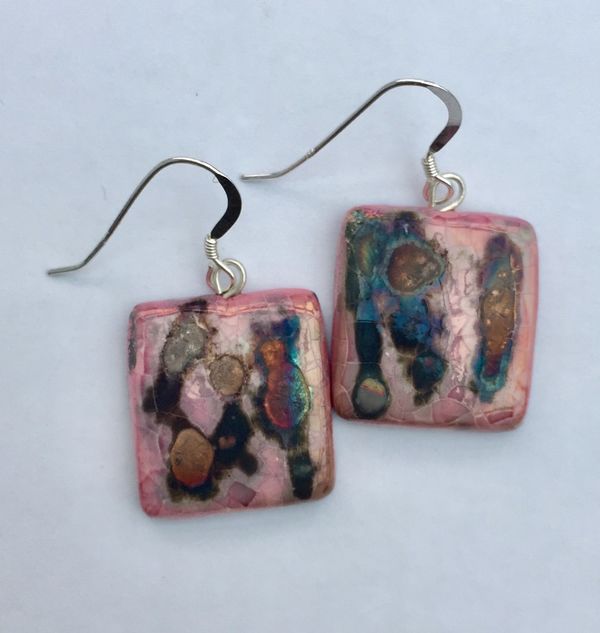 Pink square ceramic earrings with iridescent colours.