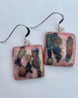 Pink square ceramic earrings with iridescent colours.