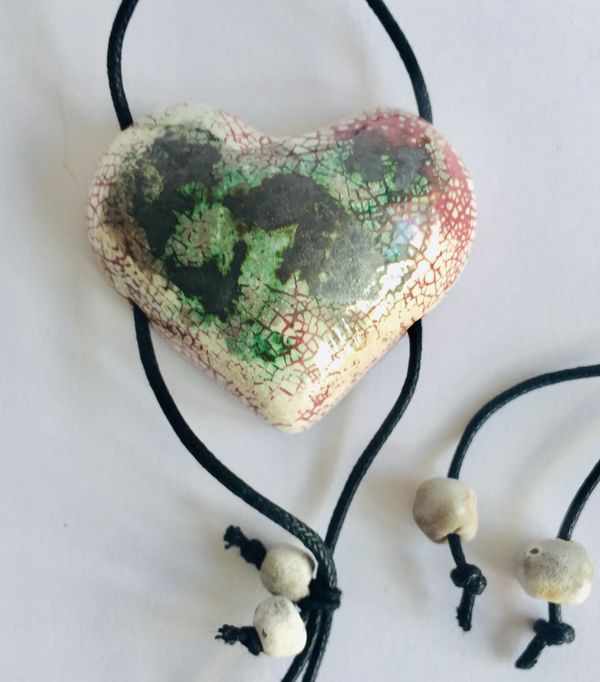 Heart pendant with black green and pink.