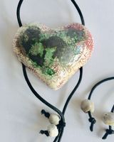 Heart pendant with black green and pink.