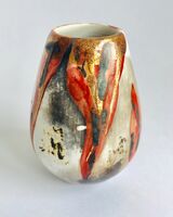 Red smoke-fired pot with gold lustre.