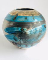 Blue smoke-fired ceramic pot with glaze and gold lustre.