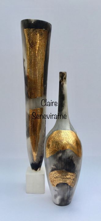 Two smoke-fired pots with gold lustre.