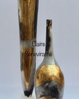 Two smoke-fired pots with gold lustre.