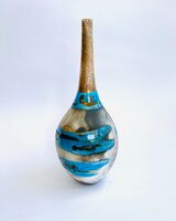 Blue smoke-fired pot with gestural markings crackled glaze and gold lustre.