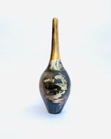 Burnished smoke-fired ceramic pot with gold lustre.