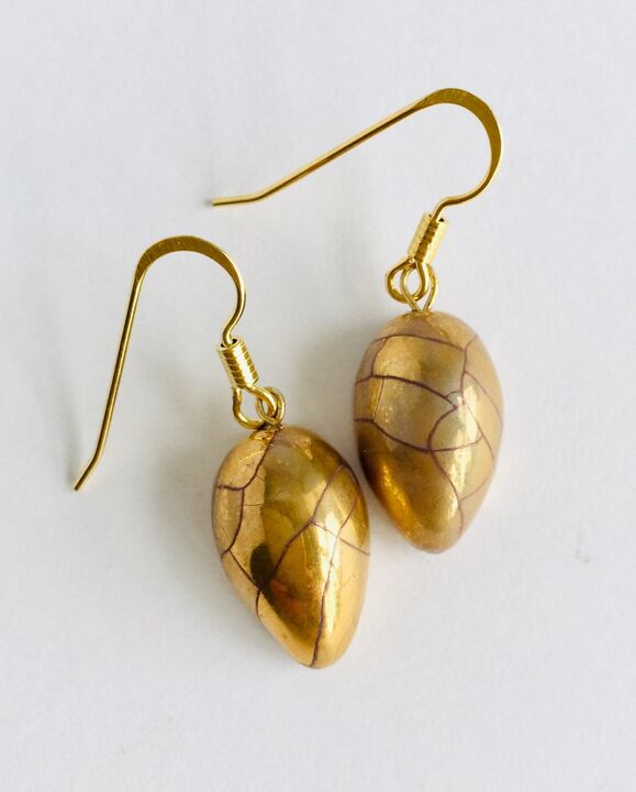 Gold teardrop earrings.