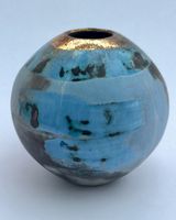 Small blue smoke-fired pot with gold lustre.
