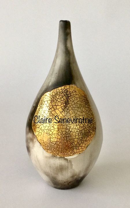 Smoked fired pot with gold lustre.
