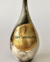 Smoked fired pot with gold lustre.