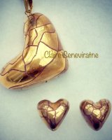 Gold lustre heart pendant hung from side with gold heart studs.