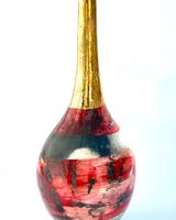 Red smoke-fired pot with gold lustre.