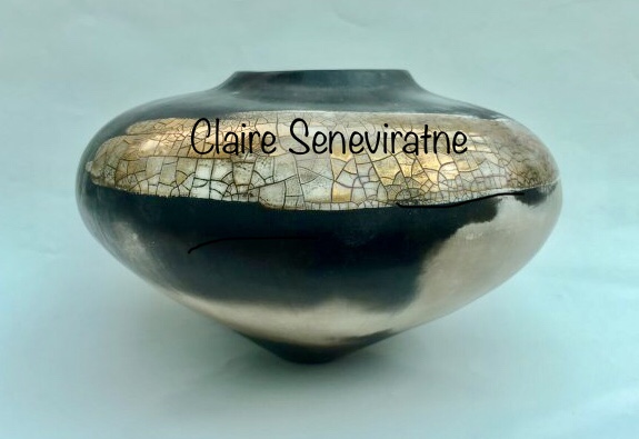 Round smoke-fired porcelain vessel with gold lustre.