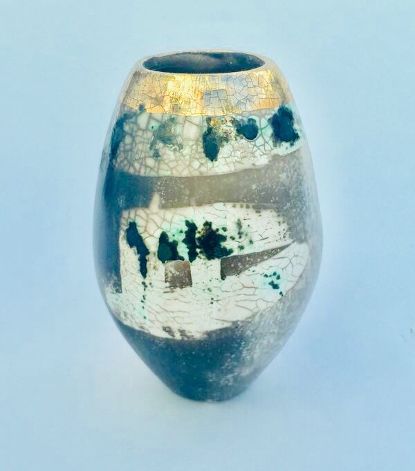 Upright smoke-fired ceramic pot with gold lustre.
