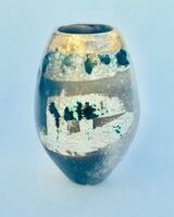 Upright smoke-fired ceramic pot with gold lustre.