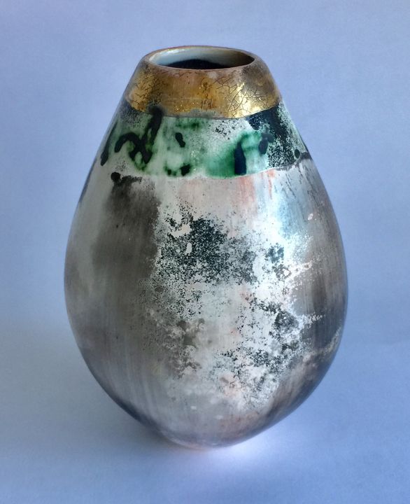 Upright sawdust fired pot with gold lustre.