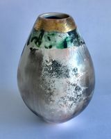 Upright sawdust fired pot with gold lustre.